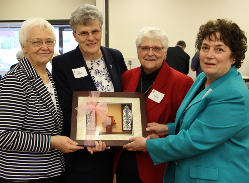 NRRO Executive Director Sister Janice Bader receives photo from the School Sisters of St. Francis’ U.S. Province leadership team. From left: Sister Marilyn Ketteler, OSF; Sister Janice Bader, CPPS; Sister Carol Rigali, OSF; Sister Deborah Fumagalli, OSF.